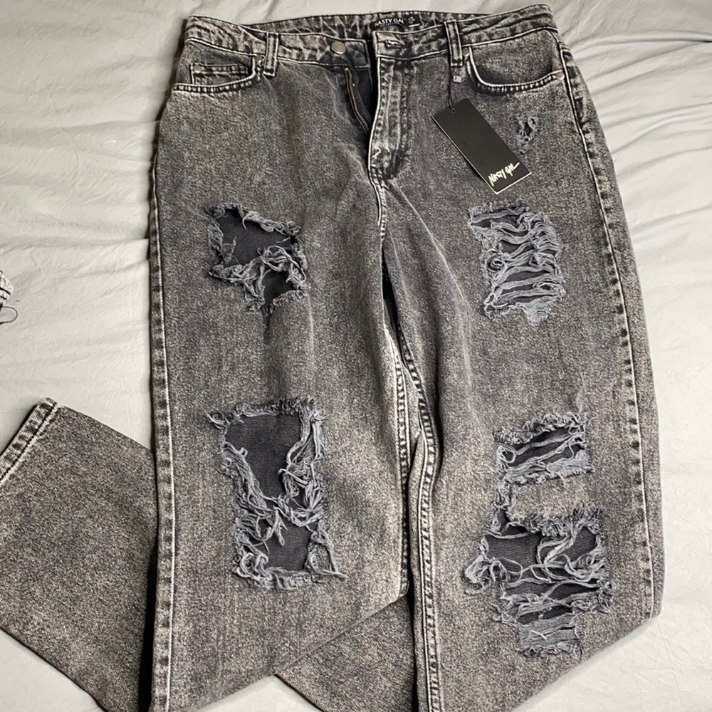 Grey/black wash jeans w/ holes.